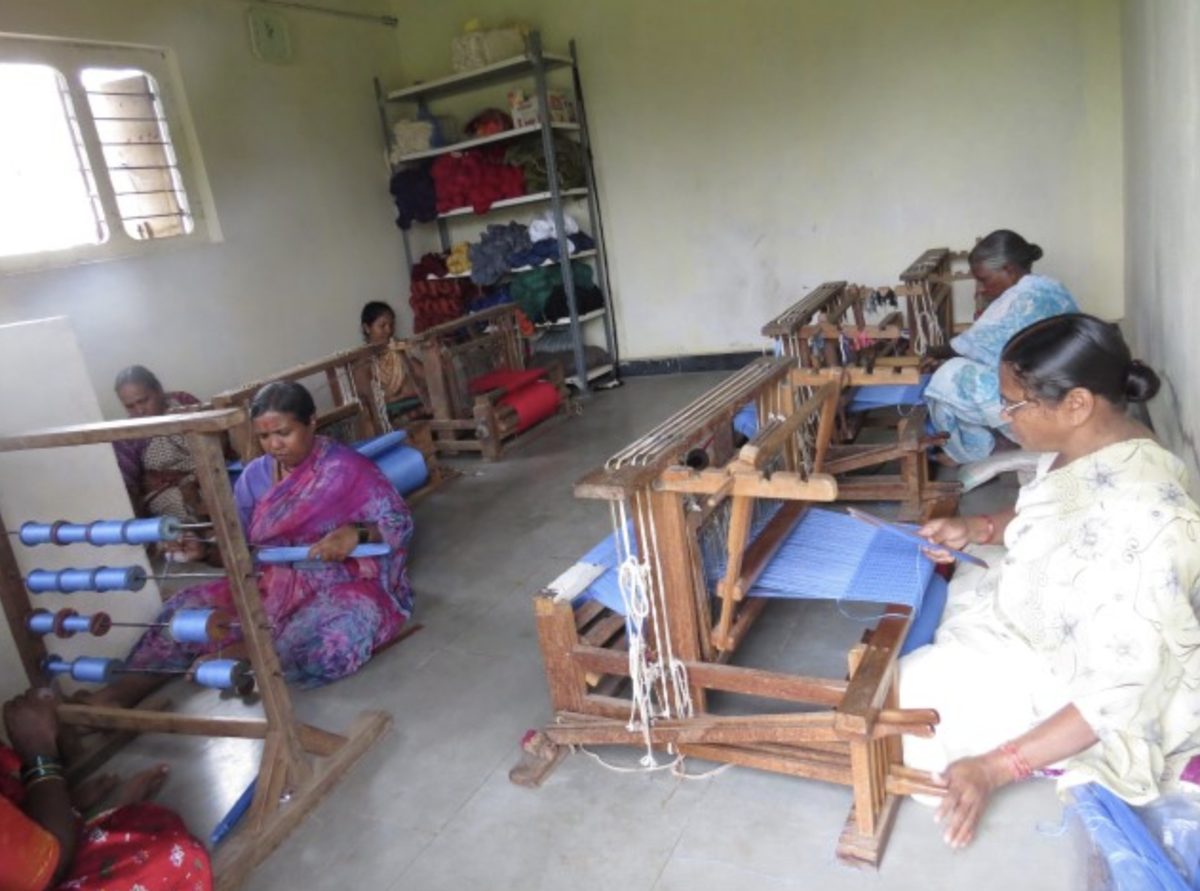 Women weave on traditional wooden looms in a partner workshop