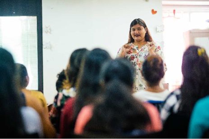 A One Weave partner leads a training session for young women in India