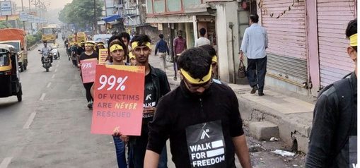 An awareness march through a city street in India